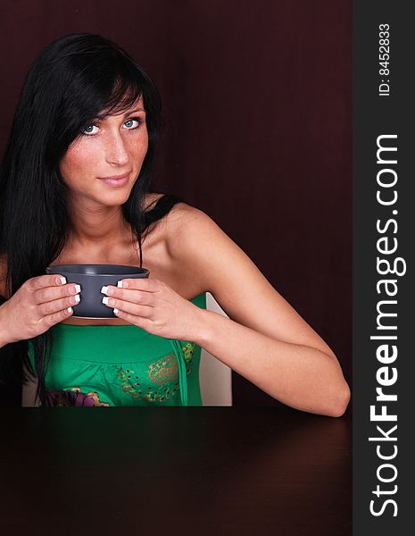 Charming woman holding a blue pot of tea or coffee. Charming woman holding a blue pot of tea or coffee