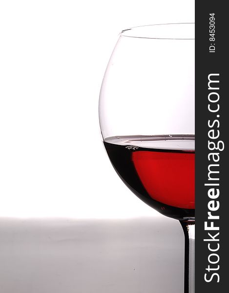 A glass of red wine on grey isolated on white with reflection