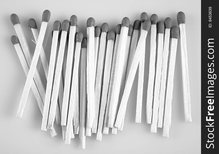 Wooden matches in black & white on white background