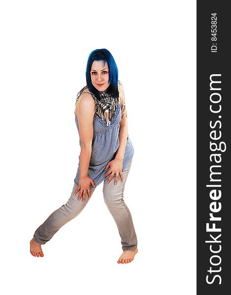 Pretty young blue haired girl in a blue short dress and jeans with a big tattoo on her arm standing on the floor for black background. Pretty young blue haired girl in a blue short dress and jeans with a big tattoo on her arm standing on the floor for black background.