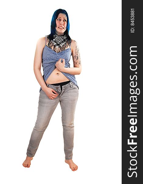 Pretty young blue haired girl in a short blue dress and jeans with a big tattoo on her arm standing on the floor and opens her jeans, for white background. Pretty young blue haired girl in a short blue dress and jeans with a big tattoo on her arm standing on the floor and opens her jeans, for white background.