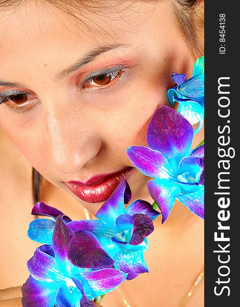 Indian girl model holding a violet flower. Indian girl model holding a violet flower.