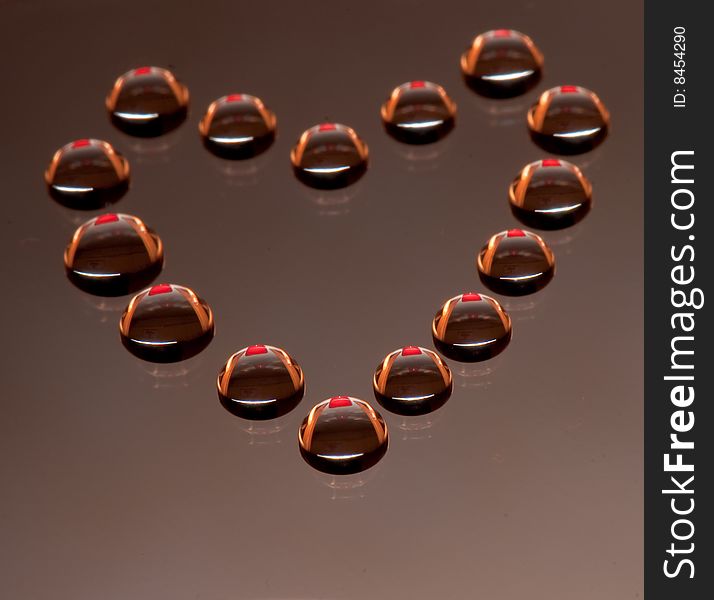 Water drops in the form of heart on a celebratory background