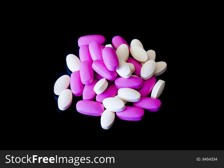 Colored oblong pills on the isolated background