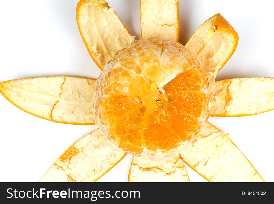 Part slice orange with peel in view flower on white