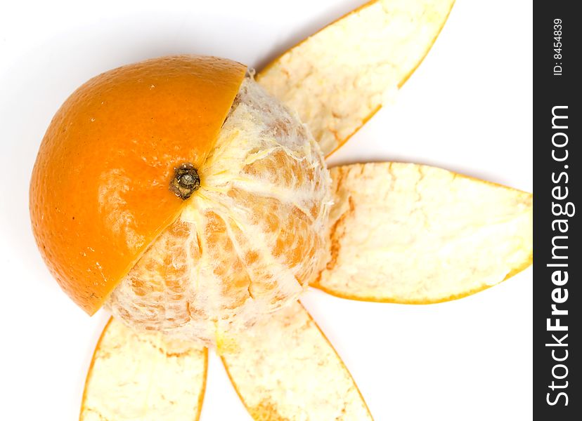 Orange, half without peel in view flower, on white