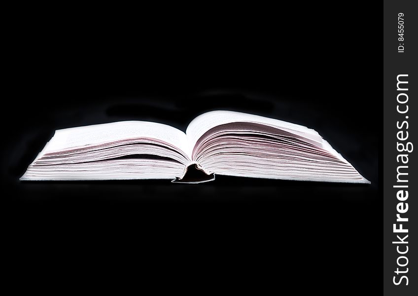 Opened book isolated on black background. Opened book isolated on black background