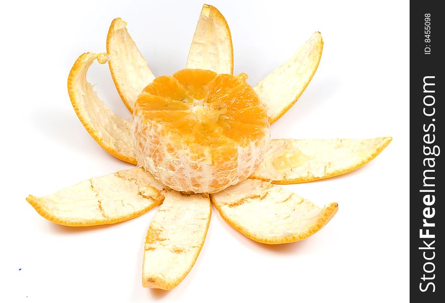 Slice orange with peel in view flower on white