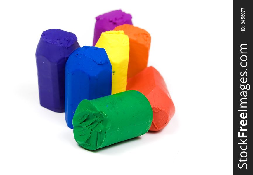 Seven wax crayons colors of rainbow on white background