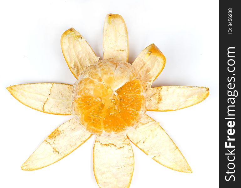 Part slice orange with peel in view flower on white