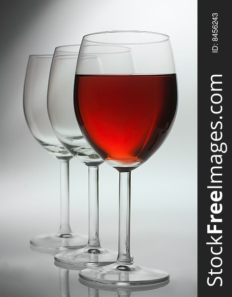 Three wine glasses over grey background