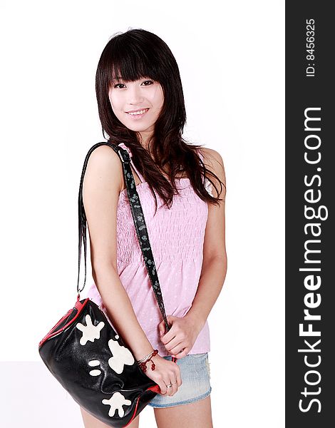 A beautiful Asian girl with handbag on white background. A beautiful Asian girl with handbag on white background.