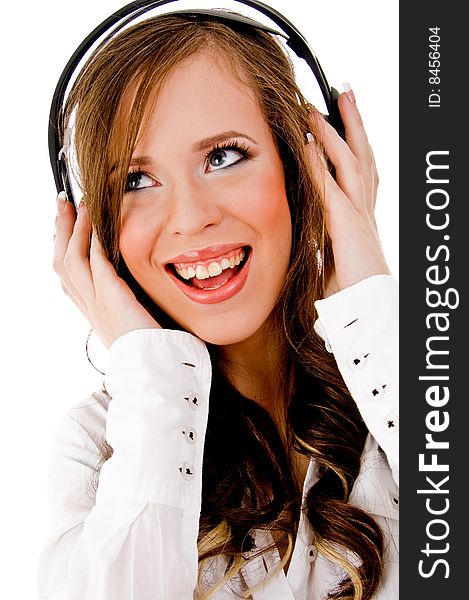 Front view of smiling female listening music with white background