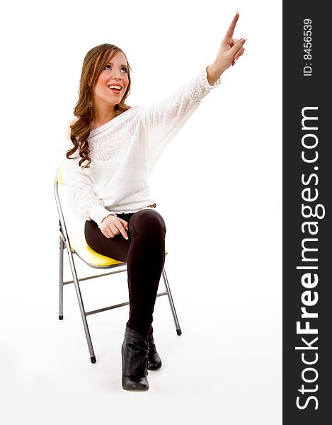 Front view of sitting female pointing on an isolated white background