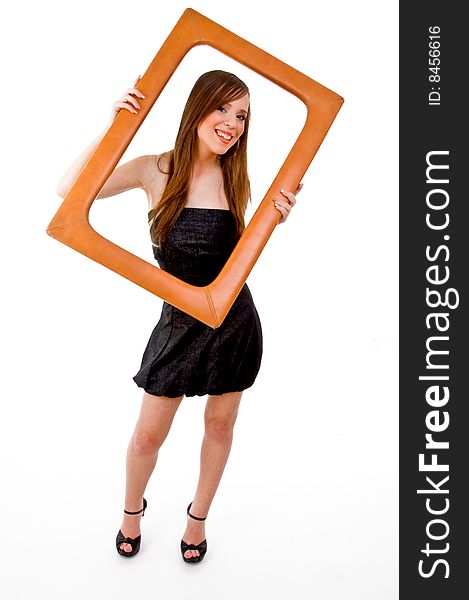 Front view of smiling woman holding frame against white background