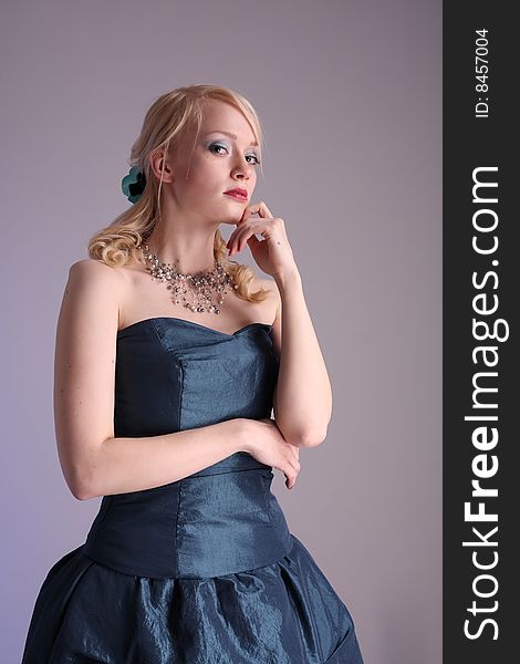 Beautiful young woman wearing a blue prom dress. Beautiful young woman wearing a blue prom dress