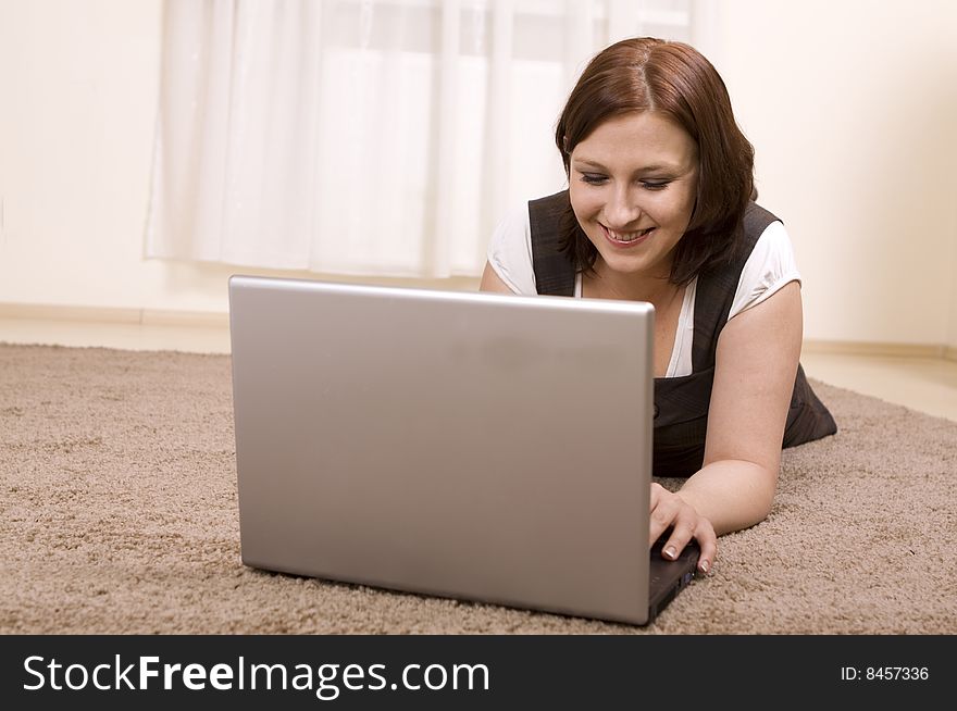 Woman with laptop on carpet