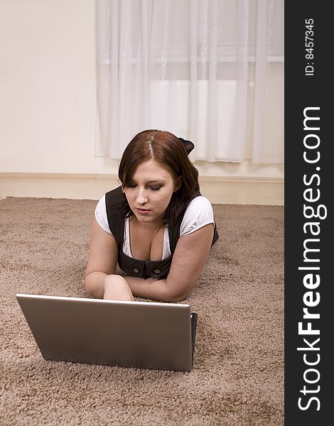 Woman with laptop on carpet