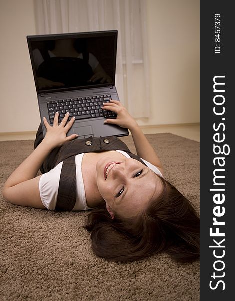 Woman with laptop on carpet