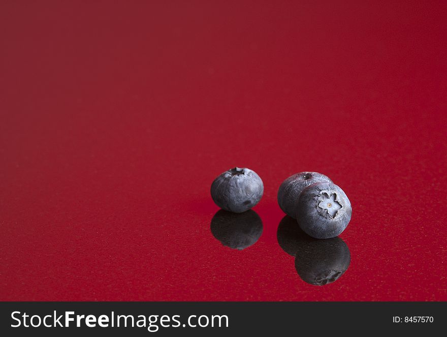 Blueberries On Red Background