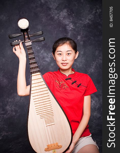 Chinese lute player in red shirt on performance. Chinese lute player in red shirt on performance