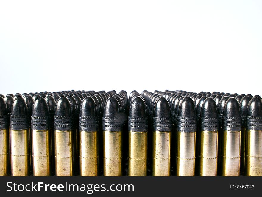 Rows of .22 calibre bullets against a white background. Rows of .22 calibre bullets against a white background.