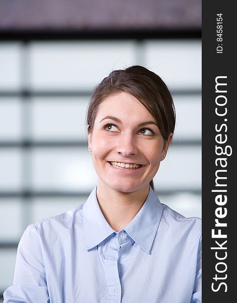 Business woman looking up in a modern office