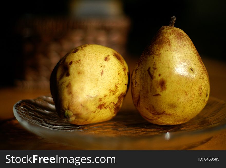 Two pears on a glass plate. Two pears on a glass plate