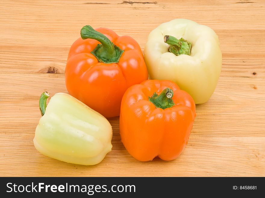Four different capsicum  orange and light green color on wood table.Check out also <a href=http://www.dreamstime.com/healthy-food-rcollection8217-resi828293>Healthy food</a>. Four different capsicum  orange and light green color on wood table.Check out also <a href=http://www.dreamstime.com/healthy-food-rcollection8217-resi828293>Healthy food</a>