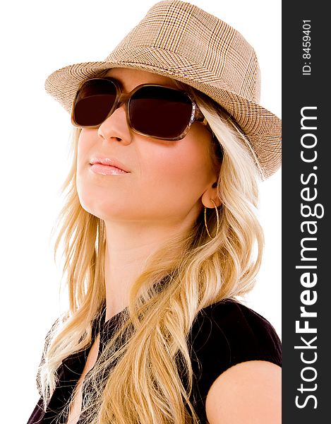 Portrait of smiling woman wearing hat and sunglasses on an isolated background