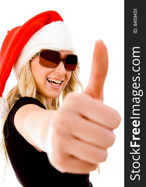 Portrait of smiling female with Christmas hat showing thumb up on an isolated background