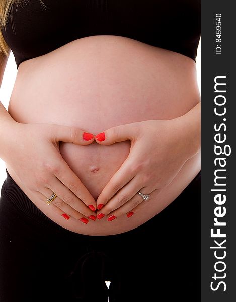 Close up of pregnant woman with her tummy on an isolated background