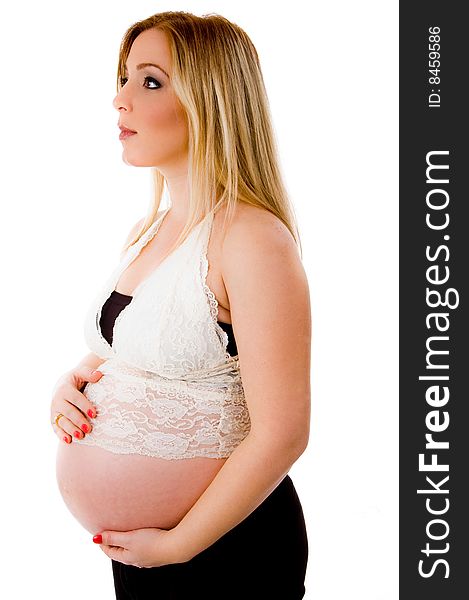 Side view of young pregnant woman looking aside on an isolated background