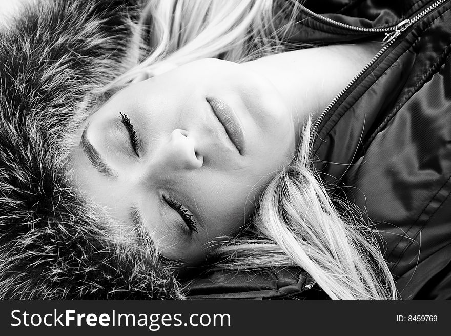 Close view of beautiful face of woman with closed eyes on an isolated background