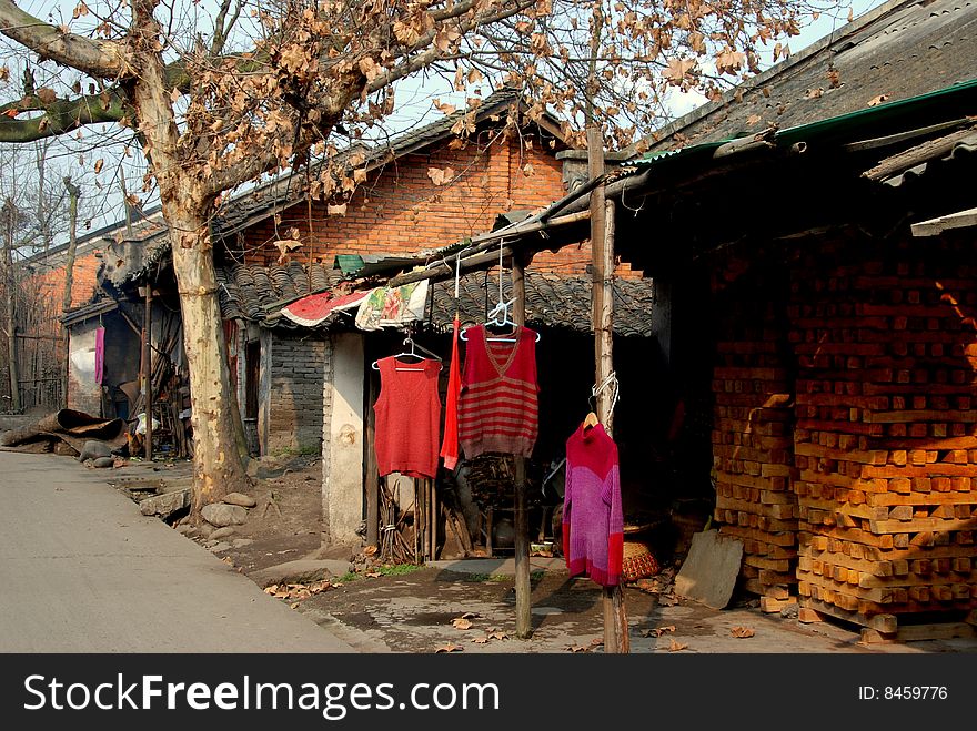 Laundry hangs in the sunshine to dry in front of old traditional brick Chinese homes in Pengzhou City, Sichuan Province, China - Lee Snider Photo. Laundry hangs in the sunshine to dry in front of old traditional brick Chinese homes in Pengzhou City, Sichuan Province, China - Lee Snider Photo.