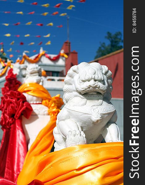 Chinese guardian lions in front of the temple, during buddhist ceremonies