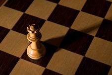 Queen Dramatically Isolated On Chess Board Royalty Free Stock Photography Queen Dramatically Isolated On Chess Board Royalty Free Stock Photography