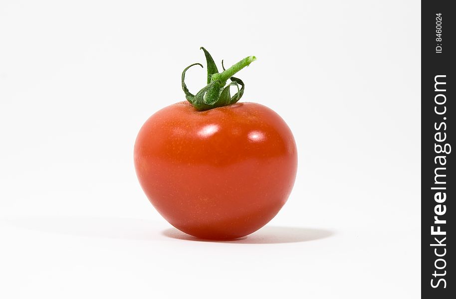 An isolated red tomato on white background. An isolated red tomato on white background