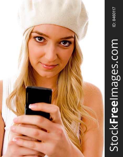 Portrait of smiling young woman holding cell phone on an isolated background