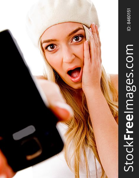 Portrait of surprised young female showing mobile on an isolated background