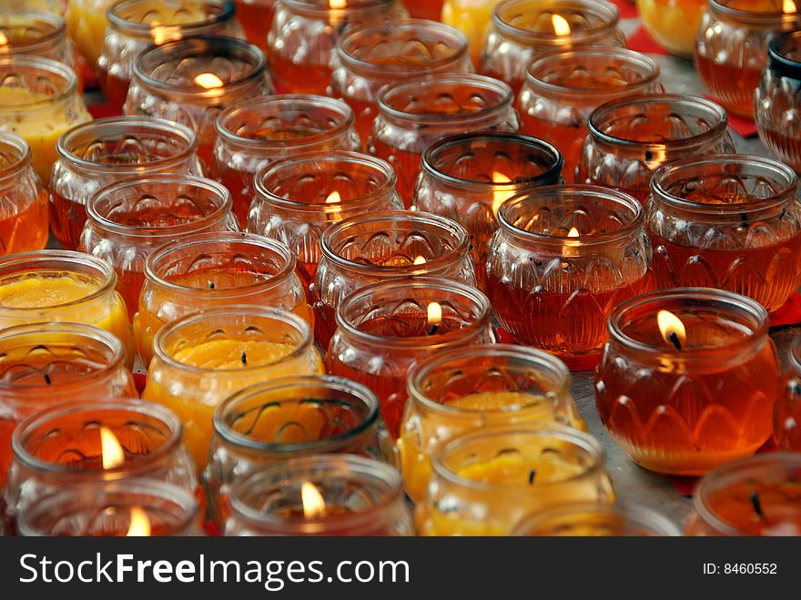 Hundreds of amber-coloured glass votive candles in a courtyard at the Long Xing Temple complex in Pengzhou, China - Lee Snider Photo. Hundreds of amber-coloured glass votive candles in a courtyard at the Long Xing Temple complex in Pengzhou, China - Lee Snider Photo.