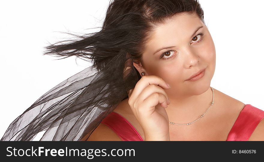 Young female model with hair blown by wind holding veil. Young female model with hair blown by wind holding veil