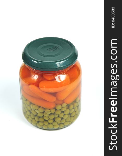 A glass jar with pre-cooked vegetables. A glass jar with pre-cooked vegetables