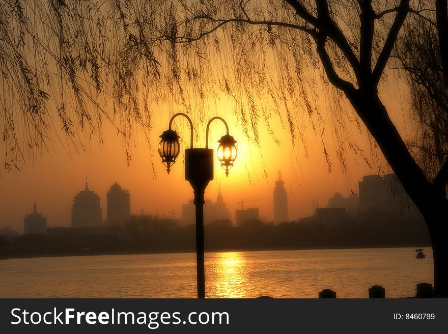 a lamp light beside a lake. a lamp light beside a lake