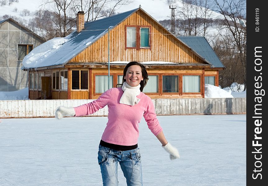 Happy young woman with ice skates