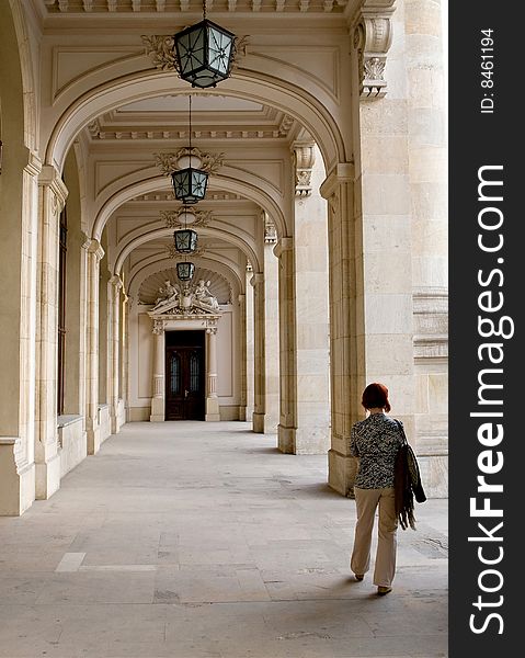 Lonely women walking near some old columns. Lonely women walking near some old columns