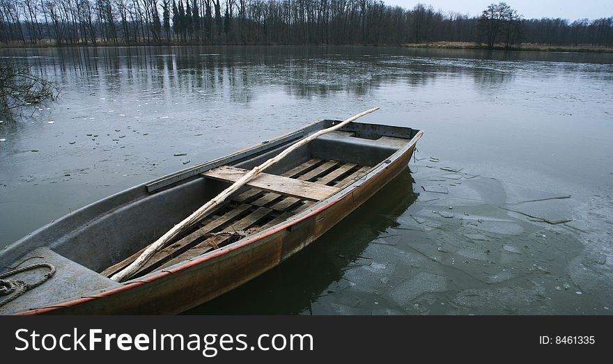 Lonely boat on the frozen lake.