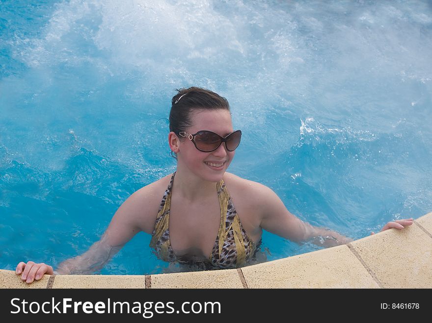 Girl in pool with hot mineral medical water