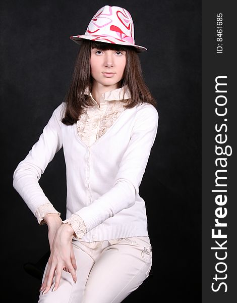 Smiling girl sitting in studio