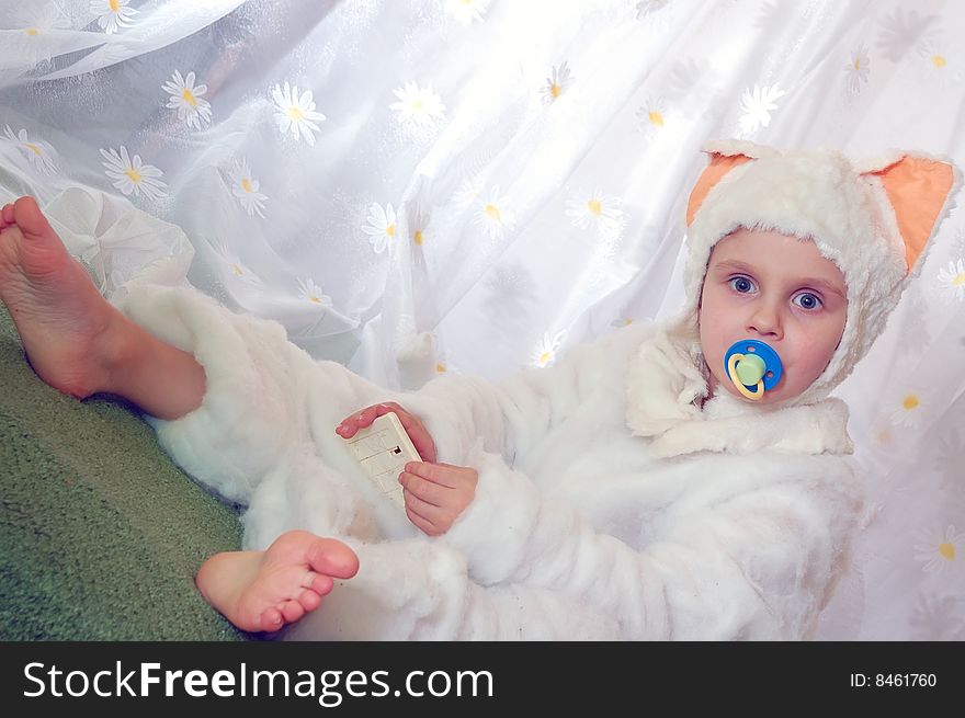 Little girl wearing feline costume with a pacifier. Little girl wearing feline costume with a pacifier